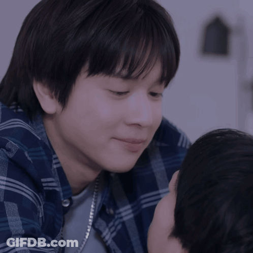 A Close Up Of A Person 'S Face With A Blue Plaid Shirt GIF