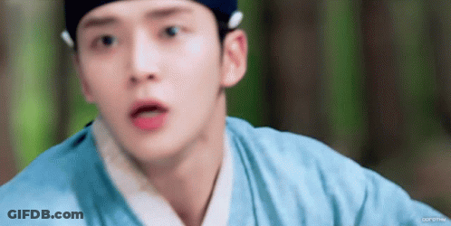 A Close Up Of A Person 'S Face With A Blue Shirt On GIF