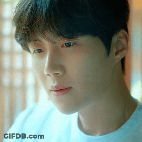 A Close Up Of A Person 'S Face With A Blue Shirt On GIF