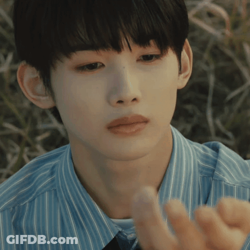 A Close Up Of A Person 'S Face With A Blue Shirt On GIF