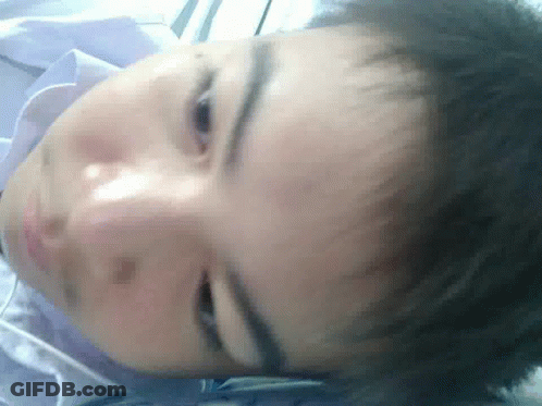 A Close Up Of A Person 'S Face With A Blue Shirt On GIF