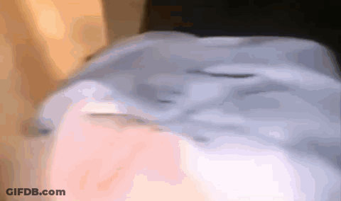A Close Up Of A Person 'S Face With A Blue Shirt On GIF