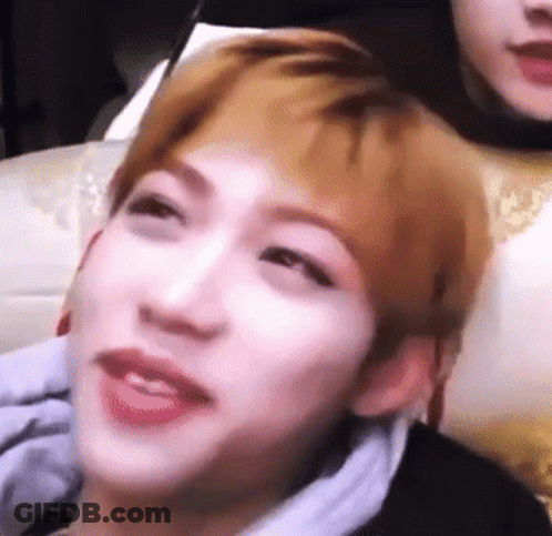 A Close Up Of A Person 'S Face With A Blurred Background And A Person 'S Head In The Background . GIF