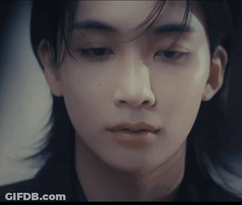 A Close Up Of A Person 'S Face With A Blurred Background GIF