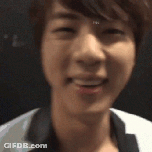 A Close Up Of A Person 'S Face With A Blurred Background . GIF