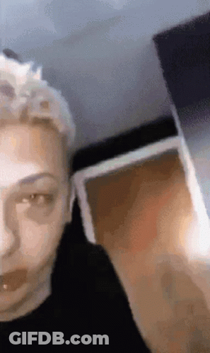A Close Up Of A Person 'S Face With A Blurry Background GIF