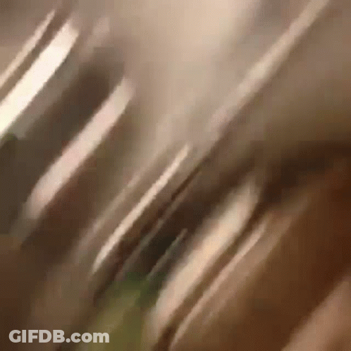 A Close Up Of A Person 'S Face With A Blurry Background GIF