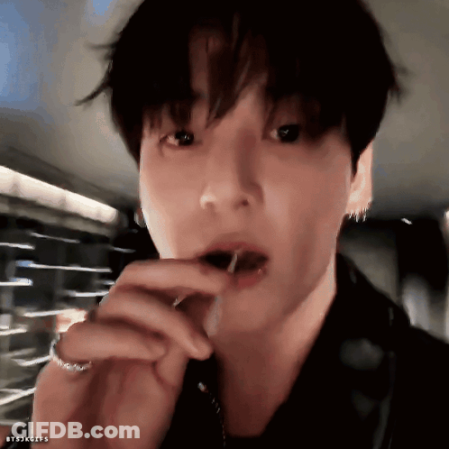 A Close Up Of A Person 'S Face With A Candy In Their Mouth . GIF