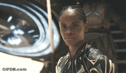 A Close Up Of A Person 'S Face With A Clock Behind Them GIF