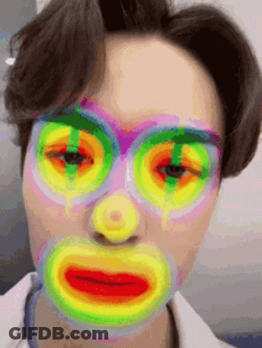 A Close Up Of A Person 'S Face With A Colorful Mask On . GIF