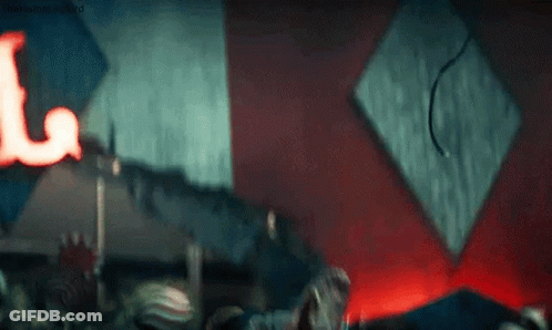 A Close Up Of A Person 'S Face With A Crown On Their Head In A Room . GIF