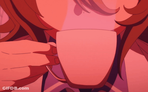 A Close Up Of A Person 'S Face With A Cup In The Foreground GIF