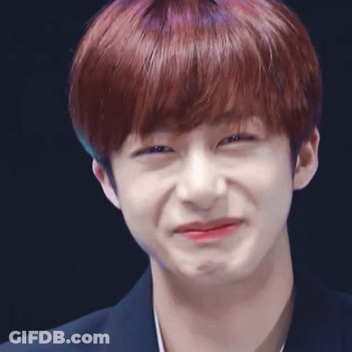 A Close Up Of A Person 'S Face With A Dark Background GIF