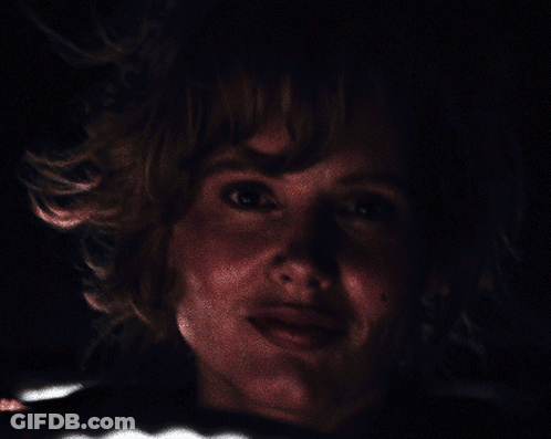 A Close Up Of A Person 'S Face With A Dark Background GIF