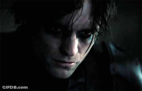A Close Up Of A Person 'S Face With A Dark Background GIF