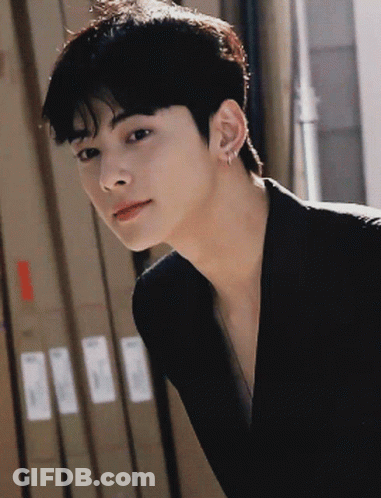 A Close Up Of A Person 'S Face With A Few Boxes In The Background GIF