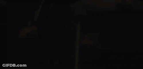 A Close Up Of A Person 'S Face With A Fire Behind Them GIF