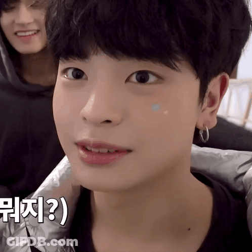 A Close Up Of A Person 'S Face With A Foreign Language Written On The Bottom Right GIF