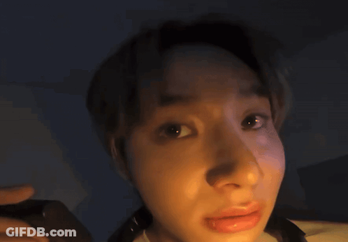 A Close Up Of A Person 'S Face With A Glowing Light Behind Them GIF