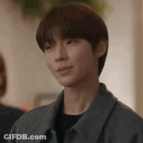 A Close Up Of A Person 'S Face With A Gray Jacket On . GIF