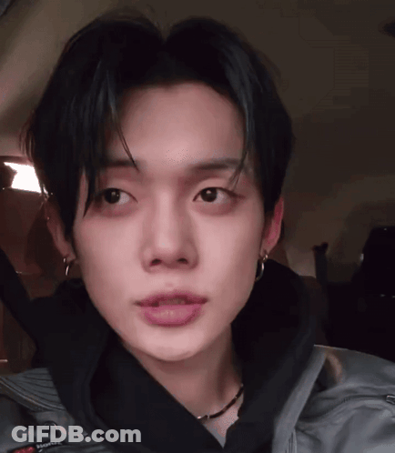 A Close Up Of A Person 'S Face With A Gray Jacket On GIF