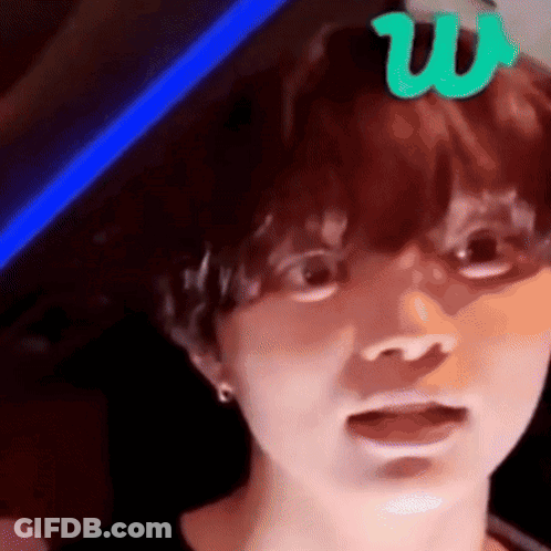 A Close Up Of A Person 'S Face With A Green Letter W On Top Of It . GIF