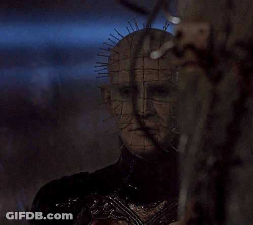 A Close Up Of A Person 'S Face With A Grid Of Spikes On It GIF