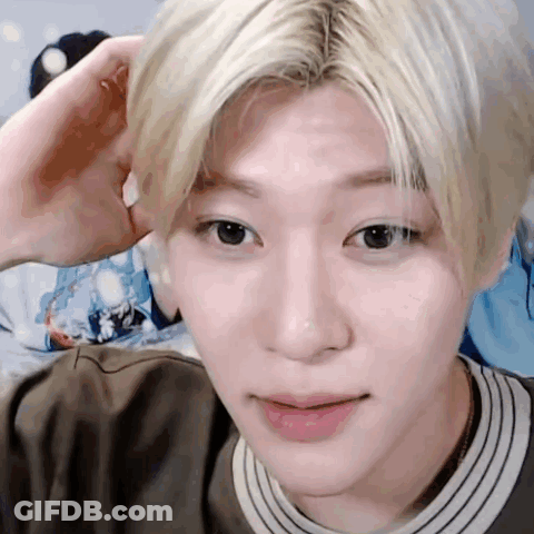 A Close Up Of A Person 'S Face With A Hand On His Head . GIF