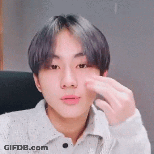 A Close Up Of A Person 'S Face With A Hand On It . GIF