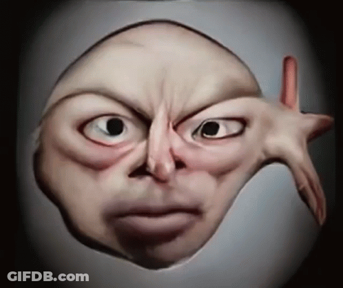A Close Up Of A Person 'S Face With A Hand Sticking Out GIF