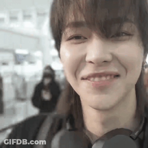 A Close Up Of A Person 'S Face With A Headphone On . GIF