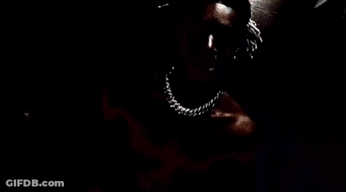 A Close Up Of A Person 'S Face With A Knife In Their Mouth . GIF
