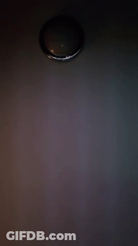 A Close Up Of A Person 'S Face With A Light Behind It GIF