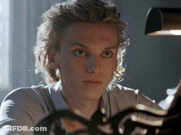 A Close Up Of A Person 'S Face With A Light Behind Them GIF