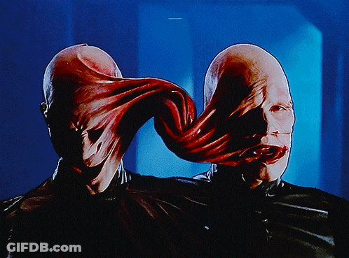 A Close Up Of A Person 'S Face With A Long Tongue Coming Out Of It GIF