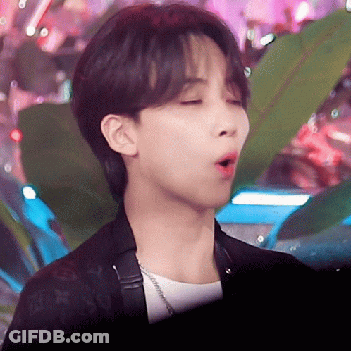 A Close Up Of A Person 'S Face With A Louis Vuitton Jacket On GIF