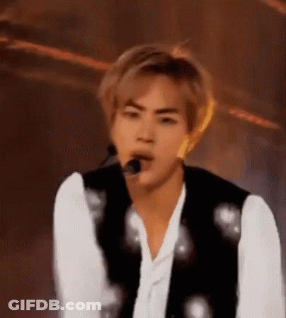 A Close Up Of A Person 'S Face With A Microphone In His Mouth . GIF