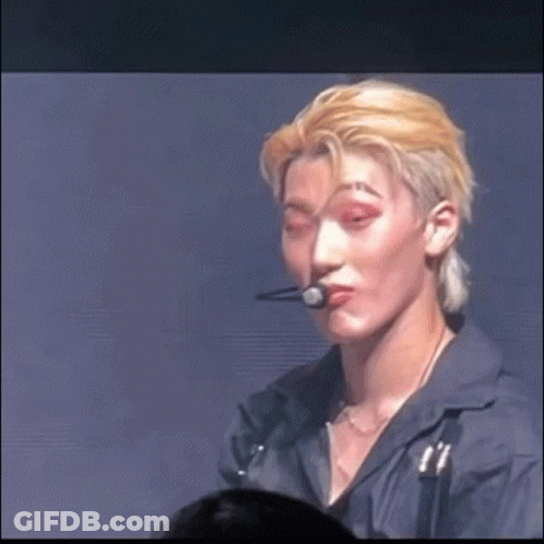 A Close Up Of A Person 'S Face With A Microphone In Their Mouth GIF