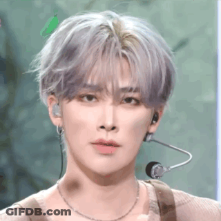 A Close Up Of A Person 'S Face With A Microphone On Their Ear . GIF