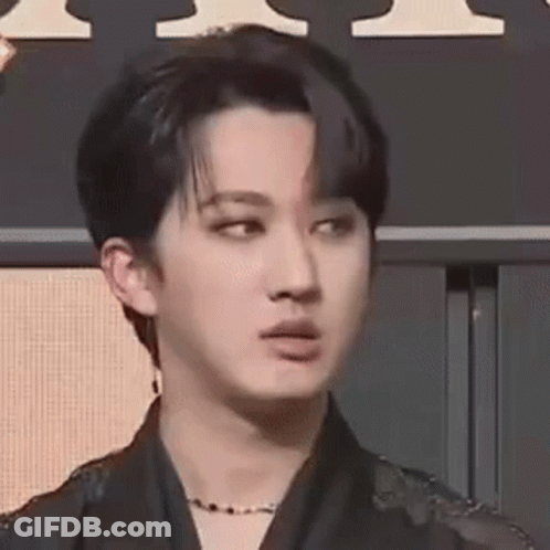 A Close Up Of A Person 'S Face With A Necklace Around Their Neck . GIF