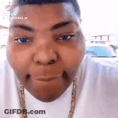 A Close Up Of A Person 'S Face With A Necklace Around Their Neck . GIF