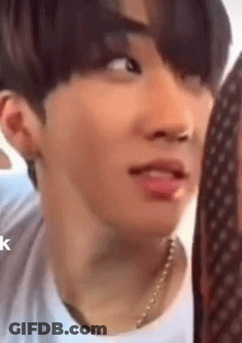 A Close Up Of A Person 'S Face With A Necklace On . GIF