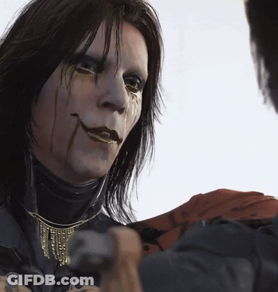 A Close Up Of A Person 'S Face With A Necklace On It GIF