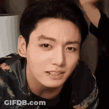 A Close Up Of A Person 'S Face With A Piercing In His Eyebrow . GIF