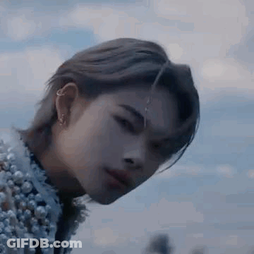 A Close Up Of A Person 'S Face With A Piercing In Their Ear . GIF
