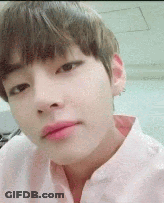 A Close Up Of A Person 'S Face With A Pink Shirt On And A Pink Lip . GIF