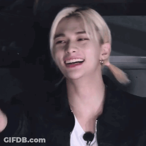 A Close Up Of A Person 'S Face With A Ponytail And Earrings . GIF