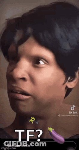 A Close Up Of A Person 'S Face With A Purple Eggplant In The Background . GIF