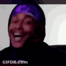 A Close Up Of A Person 'S Face With A Purple Headband On Their Head . GIF
