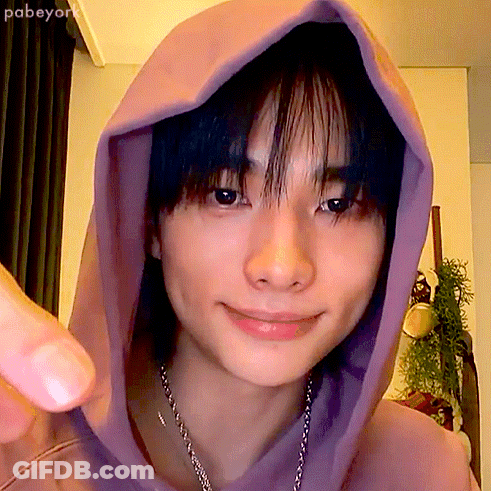 A Close Up Of A Person 'S Face With A Purple Hoodie On GIF